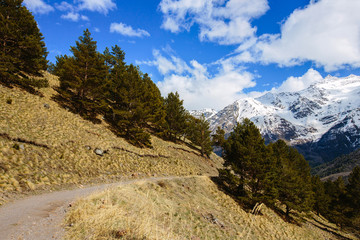 the mountain path on the background of snow-capped peaks