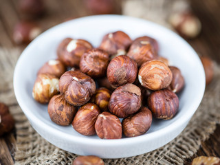 Hazelnuts on vintage wooden background (selective focus)