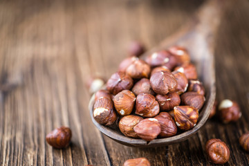 Hazelnuts on vintage wooden background (selective focus)