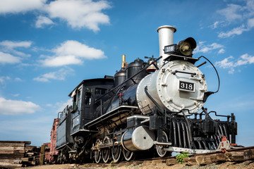 Old train engine from the west with blue sky and clouds