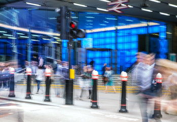 Business people walk through the City of London street. Blurred image. City of London business life concept 