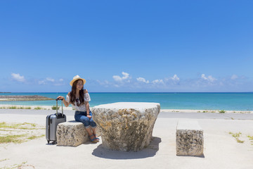 Obraz na płótnie Canvas 沖縄の海と旅をする女性