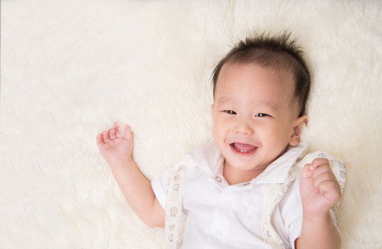 Little asian baby boy smiling with happy face