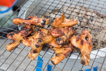 Grilled chicken legs and wings on the grill