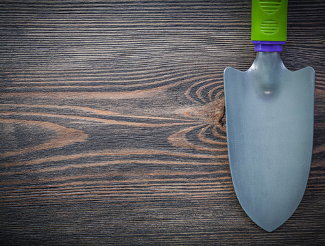 Metal trowel on vintage wooden board copy space gardening concep