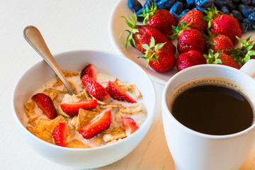 Healthy breakfast. Corn flakes with ripe red strawberry, blue ho