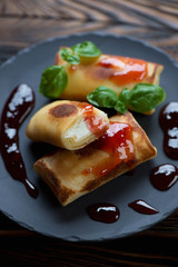 Closeup of pancakes with cottage cheese stuffing served with jam