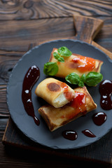 Crepes stuffed with cottage cheese, selective focus, studio shot
