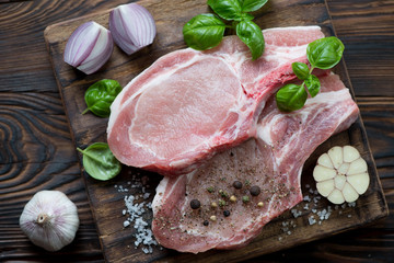 Above view of raw seasoned pork loin on bone, close-up