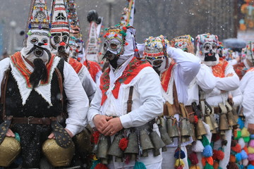 Fototapeta na wymiar Pernik, Bulgaria - January 14, 2008: Unidentified man in traditional Kukeri costume are seen at the Festival of the Masquerade Games Surva in Pernik, Bulgaria.
