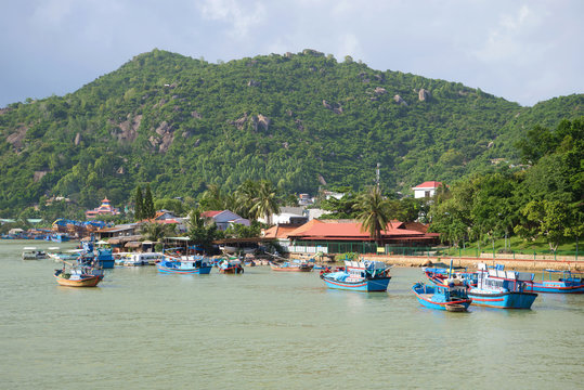 Waterfront Cai river in the vicinity of Nha Trang. Fishing boats moored near the shore. Vietnam