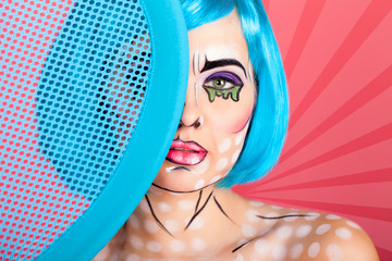 Photo of young woman with professional comic pop art make up. Creative beauty style.