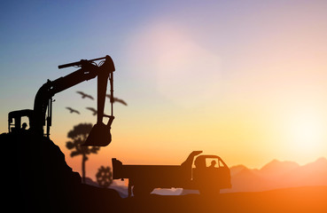 silhouette Excavator and truck working at construction site. Con