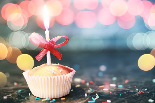 birthday cupcake with a candle bokeh