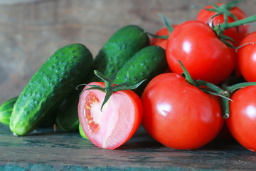 branch of tomatoes on wooden background