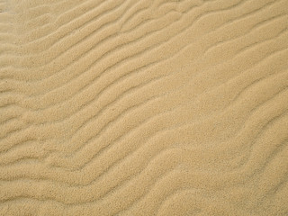 Fototapeta na wymiar Perspective unique sand pattern. Beautiful sand texture background at beach.