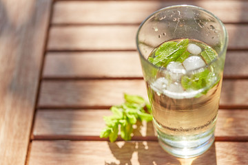 Cool drink with mint and ice on table top view