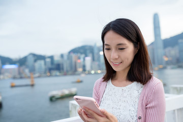 Fototapeta premium Woman use of mobile phone at Hong Kong