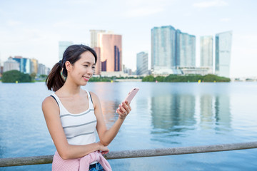 Fototapeta na wymiar Woman use of cellphone in Macau