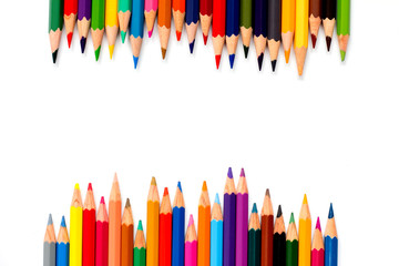 Row of color pencil placed on white background
