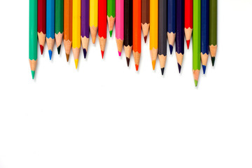 Row of color pencil placed on white background