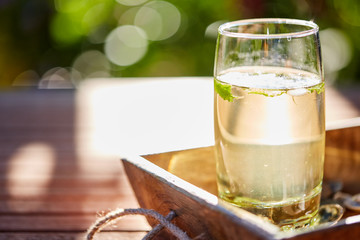 Fresh mint drink with ice in a glass on  a wooden table