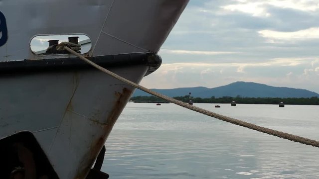 Tied down by Mooring Rope. Closeup Bow of White Ship
