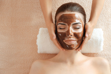 Young beautiful woman having spa procedure on her face