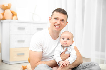 Fototapeta premium Happy father holding baby