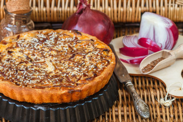 Homemade tart of red onion with sesame and flax seed. A rustic style. Selective focus
