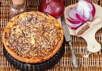 Homemade tart of red onion with sesame and flax seed. A rustic style. Selective focus
