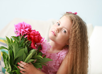 Obraz na płótnie Canvas Beautiful girl holding fresh peonies bouquet on light background