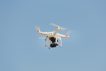 Drone flying with clear blue sky