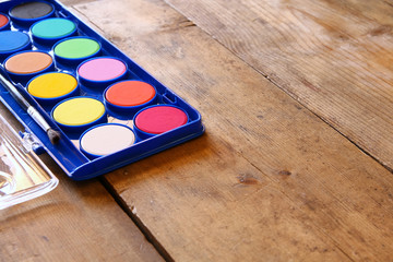 Watercolor on wooden desk. selective focus