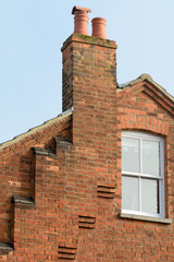 Fototapeta na wymiar Chimney breast with a series of steps leading up to roof on Victorian house