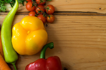 Spring fresh vegetables on the wooden background with copyspace