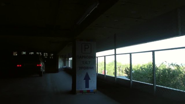The car goes through a multi-storey overground parking, the view from inside the car
