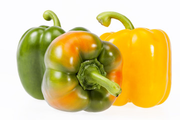some vegetables of yellow and green pepper on white background