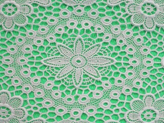 White doilie over light green background