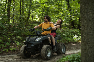 man and woman riding on an ATV