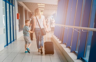 Woman and her child passing through the airport