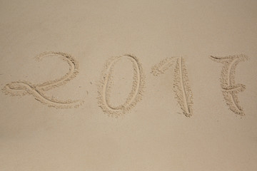 2017, message written in the sand at the beach