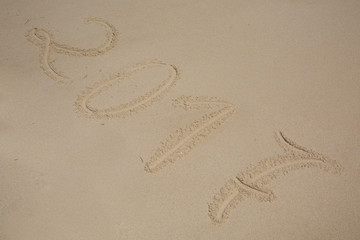 2017, message written in the sand at the beach