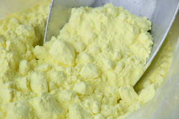 sulfur on iron scoop in plastic bag