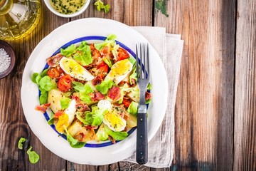 potato salad with eggs, lettuce,  tomatoes and bacon