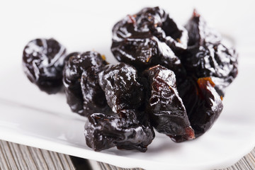 Prunes over white plate