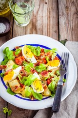 potato salad with eggs, lettuce,  tomatoes and bacon