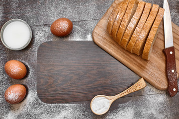 Ingredients for the preparation of bakery products. Bread, flour, eggs and cherry tomatoes.