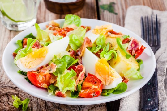 potato salad with eggs, lettuce,  tomatoes and bacon