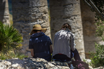 Two artist painting old greek temple at Segesta, Sicily, Italy